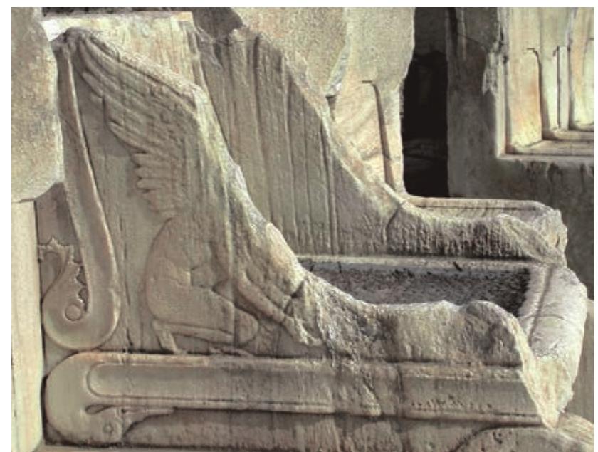 Fig. 7. Throne of the Priest of Dionysos, lateral view  Fig. 8. Throne of the Priest of Dionysos, view of better-preserved side, with winged youth, acanthus spray and bird head terminus 