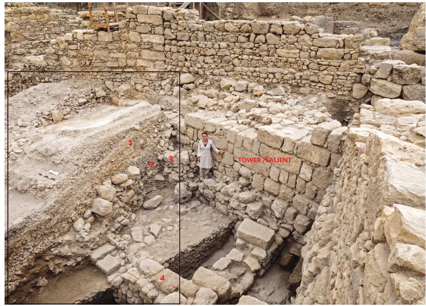 Fig. 3.3. View of the salient and the gravel-system glacis, looking northeast. The black box outlines the eastern side of Section 28. At the top are the layers of the gravel-sys- tem glacis (1). These cover one edge of the lower fills (2, most of which were exposed farther south) and the lower remains of the drainage shaft (3). At the bottom can be seen the walls of the third- to early second-century BCE domestic structure (4; see fig. 2.2 in this volume, Area 50, Domestic Structure A). Photograph by Assaf Peretz.  Zilberstein 