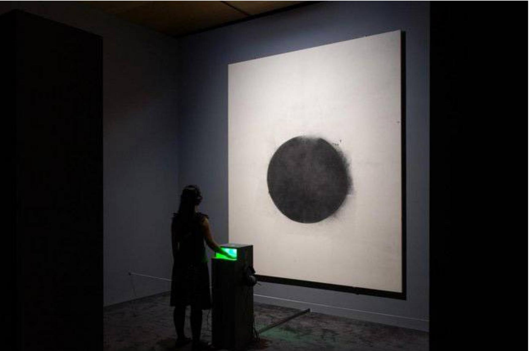 Fig 2. Tate Sensorium exhibition at Tate Britain in 2015, installation shot of Full Stop (1961) by John Latham © John Latham Estate.  Photo: Tate. Illustration of a participant experiencing the second painting combining vision, auditory, and haptic. 