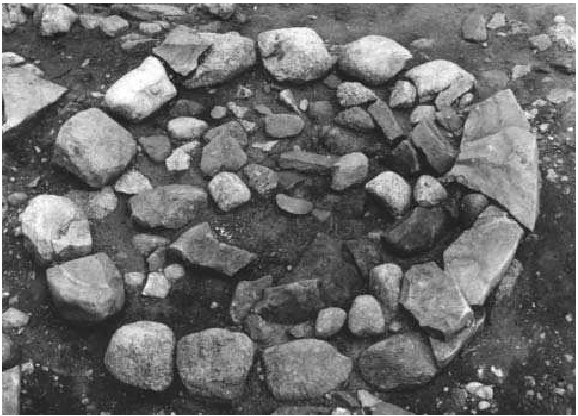 Fig. 7:1 Bhr 1967:04.Vendel Period. Flat stone setting with igneous stone kerb covered with sandstone flake brim. Diam 2.0 m. Photograph by Gustaf Trotzig 1963 (ATA). 