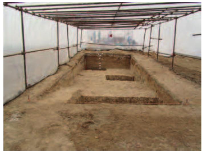 Fig. 12. Trench GH34 looking north after excavation.  Fig. 13. Sondage into natural in the NW corner of Trench GH34.  The excavation was initially carried out within 10 x 10 m squares named after the edges of the square: thus the square at the north corner of the grid is Square AB67 (Fig. 8). The first trench excavated, GH34, measuring 5 x 10 m, contained no traces of architectural or other features (Fig. 12). However, pottery fragments dated to Iron Age III (corresponding to the Median period) were recovered. After reaching natural clay mixed with gravel (Fig. 13), the excavations were shifted to the elevated part of the tappeh. 