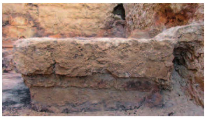 Fig. 24. The altar from the south.  Fig. 23. Sondage through the floor of Room | next to the east wall in the southern part of the room. 