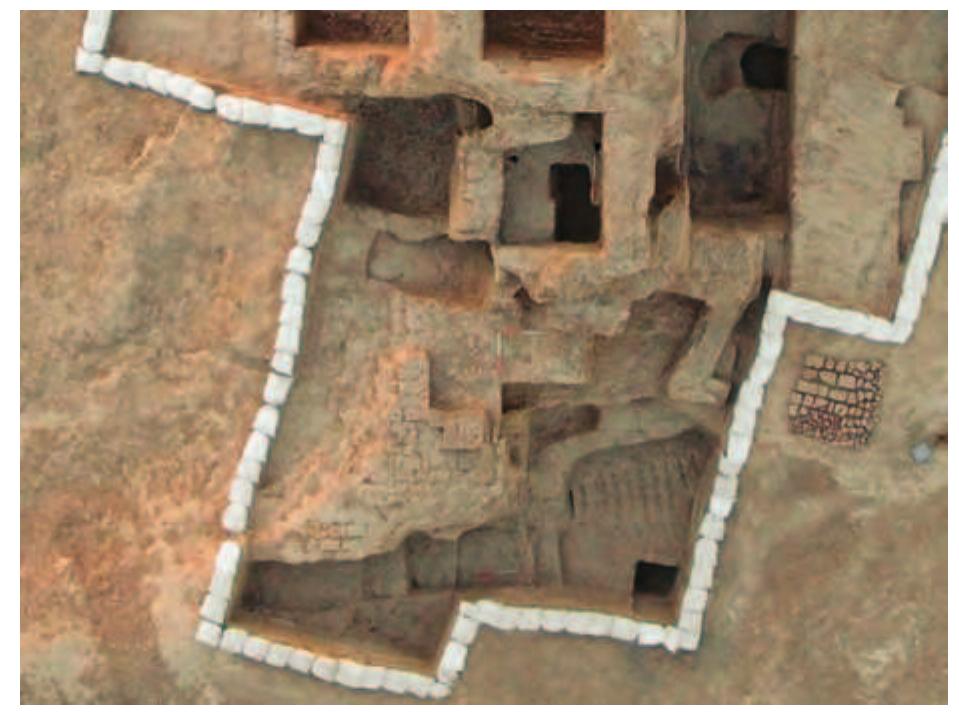 Fig. 49. Air view of the southern part of the excavated area.  Room 4 was in line with Room 2 although slightly narrower. It meas- ured 3.20 m long (N-S) and 2.40 m wide (E-W). The east walls of Rooms 2 and 4 were aligned, but the east wall of Room 4 lined up with the edge of the “platform” along the west wall of Room 2. As noted above, there was probably originally a doorway from Room 4 into Room 2. Room 4 was not completely excavated and so the south side of this doorway was not inves- tigated (Figs. 50-51). There was probably also a door from Room 4 into Room 6 but this could not be confirmed because looters’ pits prevented excavation to the floor. 