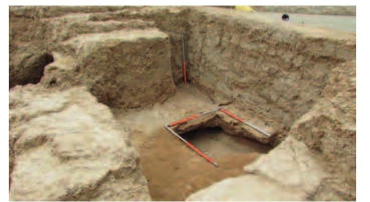 Fig. 51. View over Room 4 from the south-west. The measuring rods are resting on the upper floor. 