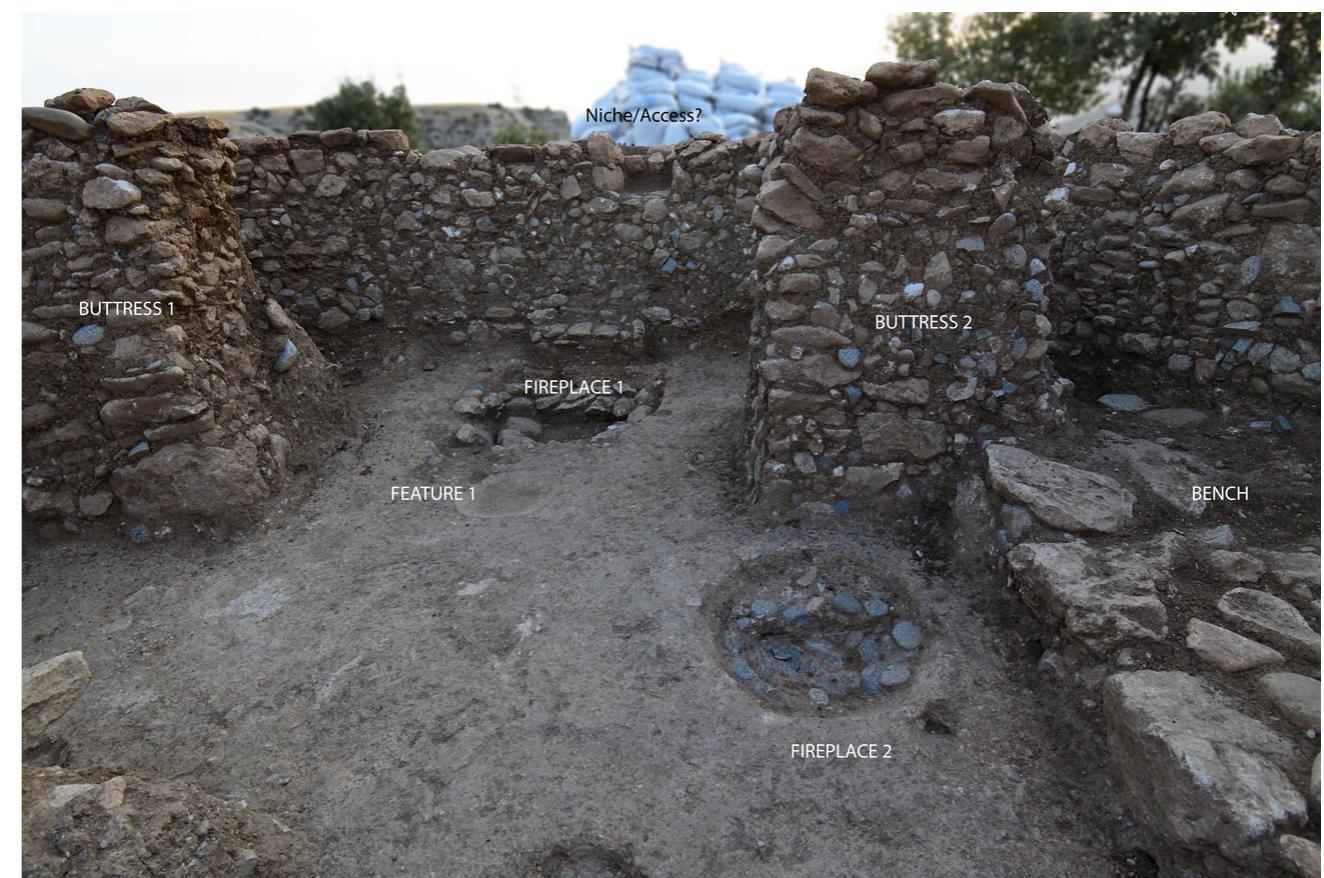 Figure 13: Boncuklu Tarla: Interior of Building GD4 (Photo: M. Kinzel, 2021, DAI-IST).  animal remain deposited on a layer of river pebbles could hint as well towards ritual practices as the last activities taking place in the building. However, an accident related to the collapse of the roofing cannot be ruled out as the stone layer the bones are found on, could stem from the roofing. The floor material has not yet been studied in detail. It appears to be a (lime) plaster floor, which seems to have been renewed at least once. However, further future studies of the floor and the deposits on it may help understand the activities and practices inside GD4 and its construction during the Neolithic. 
