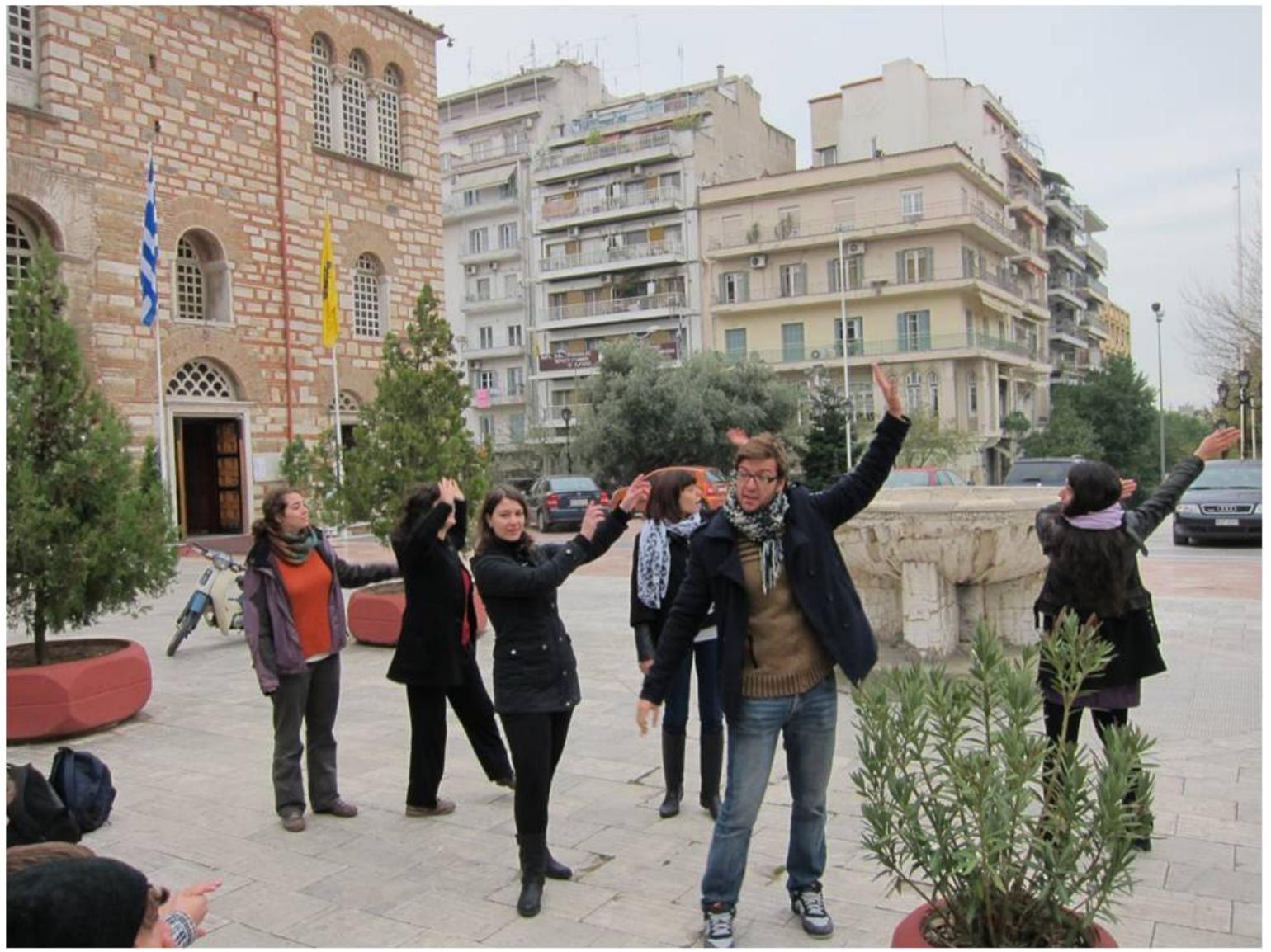 Empire and it still stands today as a landmark of contemporary Thessaloniki. As a significant part of the city’s identity, the church courtyard offered a starting point for the narrative of the city’s history that began in 315 BC. Through the use of storytelling, first person interpretation and short performances, interpreters highlighted key events of the city’s history until its liberation from Ottoman rule in 1912, underlining its rich cultural heritage.  Firstly, interpreters introduced themselves and commented on their favorite experience in the city. Then, a storyteller imitating the attitude of a traditional teacher started narrating key aspects of the city’s history: its foundation, its main characteristics in different eras, its strong multicultural character during the Ottoman rule and its lasting traits throughout the centuries. Short theatrical sketches interrupted and animated the teacher’s narrative, filling it with events, stories and myths. The storyteller also referred to the church’s history and in that framework a short scene depicting an annual feast of the twelfth century honoring St Demetrius was performed and supported by the use of objects. The performance closed with a reference to the diverse cultural sites and monuments of the city. During the performance three open-ended questions addressed to the audience aimed to link audience’s experience to the issues raised by the performance: How might living in a multicultural city might have felt like? What is a monument? What does a monument ‘mean’ to us? Rhetorical questions focusing on concepts of citizenship were also addressed. 