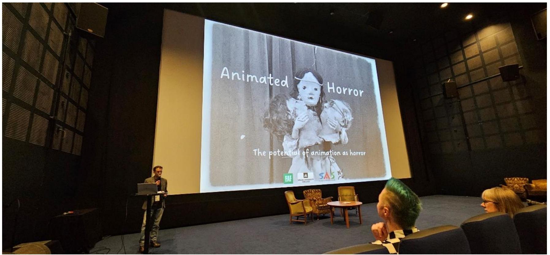 Figure 1 Associate Professor, Endre Eidsaa Larsen, welcoming the audience to the symposium  The "Animated Horror Symposium: Unveiling the Potential of Animation as a Medium for Horror’ was a landmark event that brought together a diverse group of experts, each contributing unique insights into the world of animated horror. The symposium featured a lineup of notable speakers, each delving into various facets of the genre, thereby enriching the overall understanding and appreciation of animated horror. 