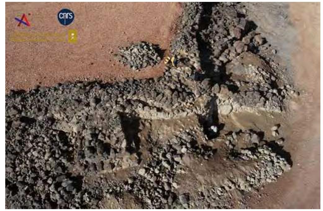 Fig. 3. View of the ramparts KH00905-KH00906 and a bastion KH00974 during excavation (see Fig. 9), looking west, © Khaybar LDAP K. Guadagnini.  ig. 2. Aerial views of the dry-stone basement of the outer rampart: A. Segment KH00911 facing south; B. Segment KHO1130 facing north; C. Segments KH00904- H00905 and KH00906 facing south; D. segment KH00922, © Khaybar LDAP, G. Charloux. 