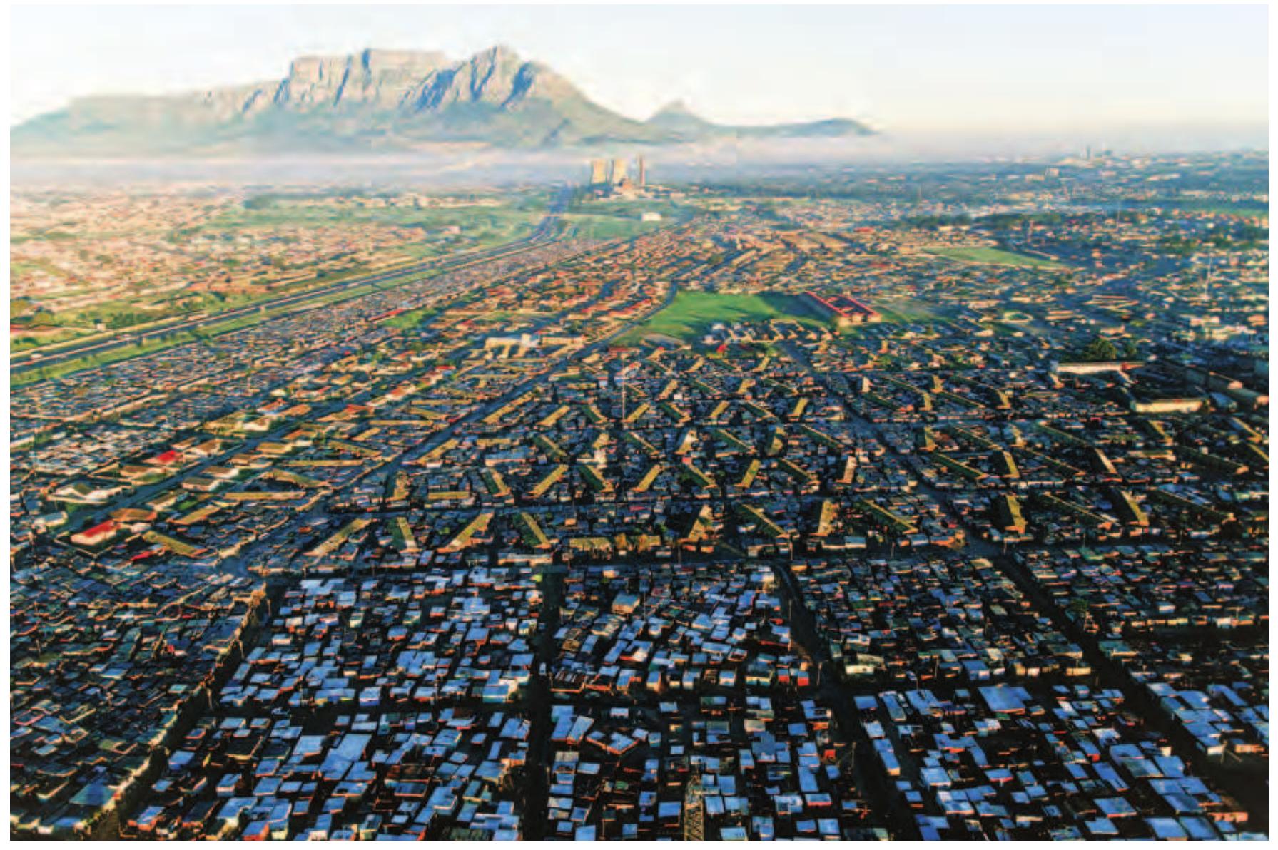 But is this environmentality the same thing as a collective love of the Table Mountain? Are these more-than-representational effects to sustain a “landscape culture” that tran- scends differences in what Table Mountain means to Capetonians, according to who they are and where they live?  FIGURE 14.20  But is this environmentality the same thing as a collective love of the Table Mountain?  An aerial view of Table Mountain from Cape Flats, early twenty-first century. 