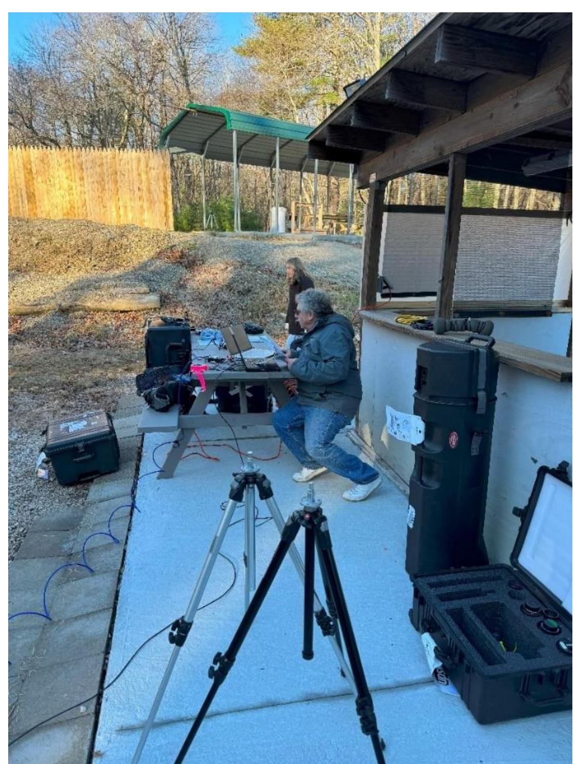 Figure 2. Videographer John Beck field processing data from the high-speed camera after a shot. 