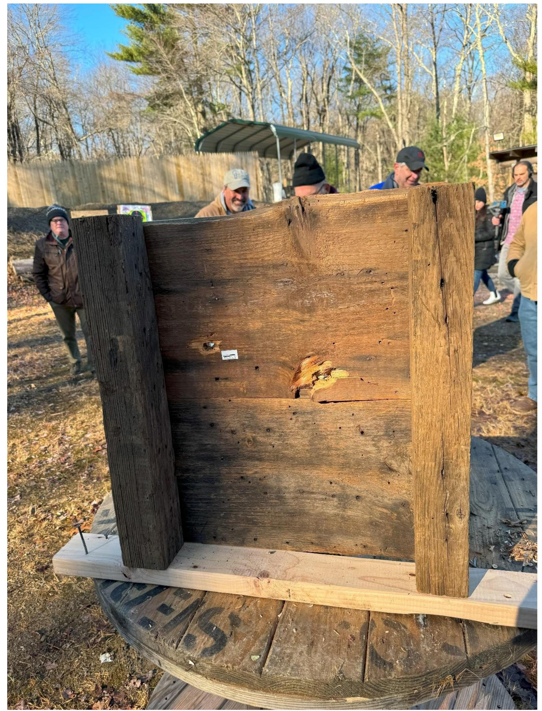 Figure 22. Wood splintering around the bullet holes in Wall 2. Note the extreme splintering around the  lower hole near the feather edge joint which nearly duplicates that found on the interior of the Elisha Jones shed sheathing.  