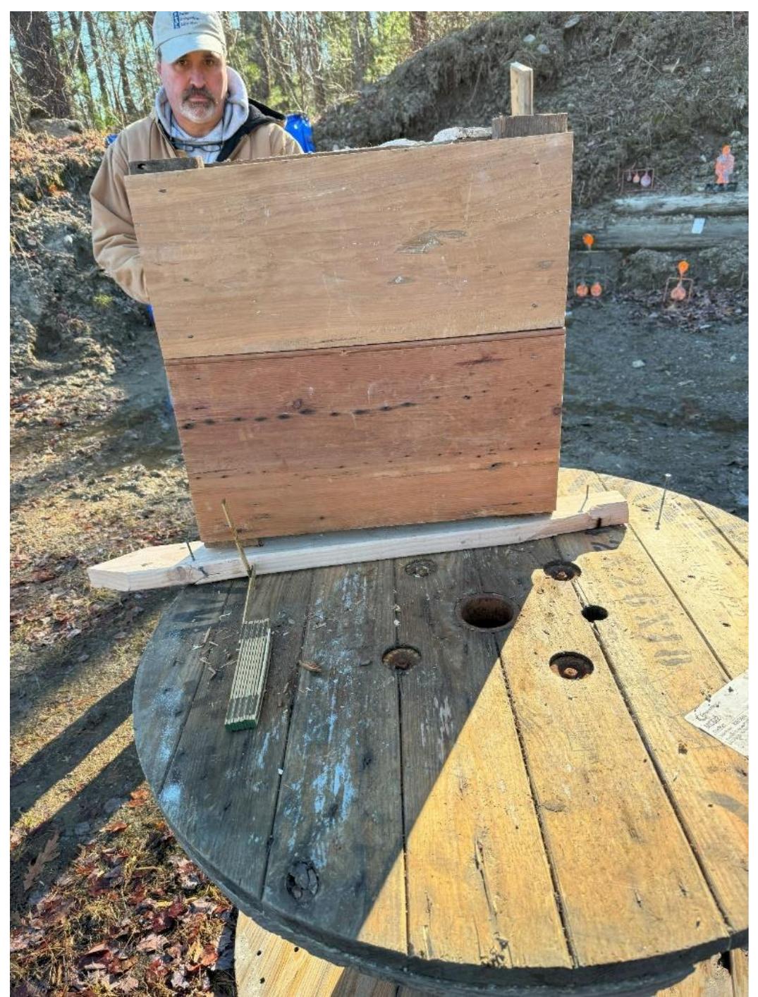 Figure 23. Jay Waller stands behind the interior panel side of Wall Section 3 prior to shooting. 