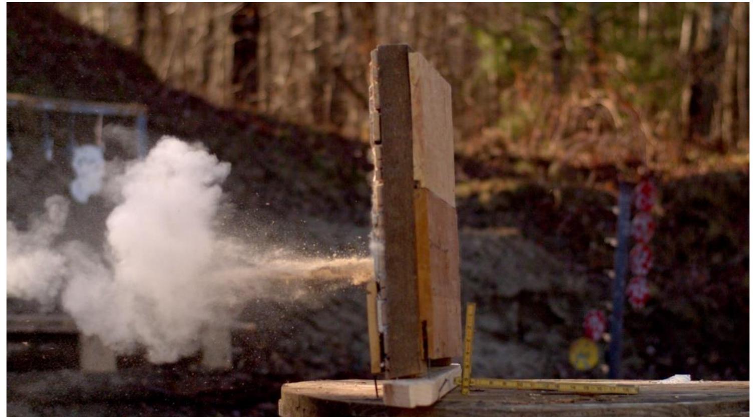 Figure 25. Still frame from the high-speed video showing the plaster dust and lath splinters resulting from the ball passing through Wall Section 3. 