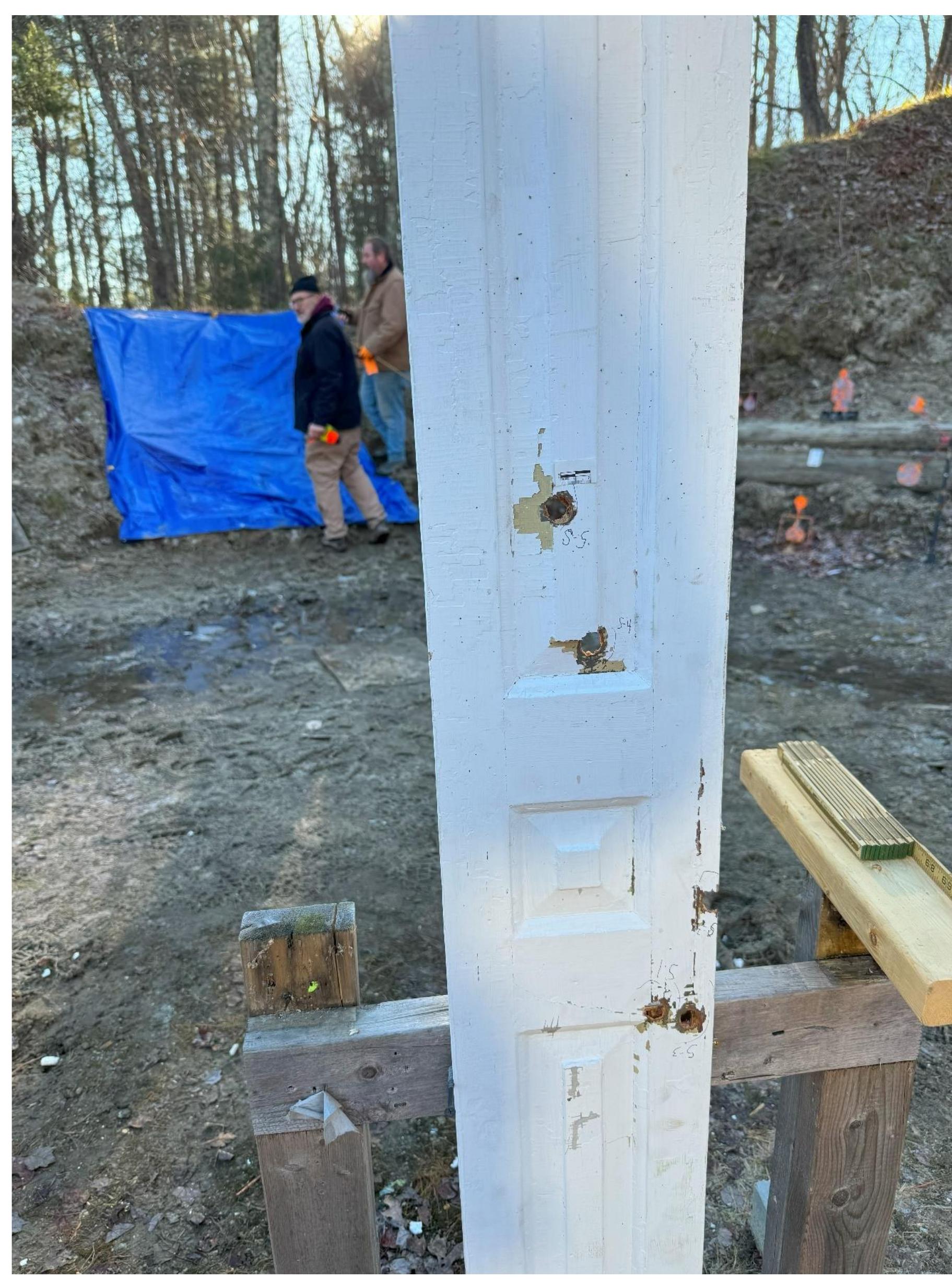 Figure 29. Five bullet strikes in a salvaged indoor window shutter that replicates bullet strikes observed in surviving shutters in the Arlington Historical Society collection. 