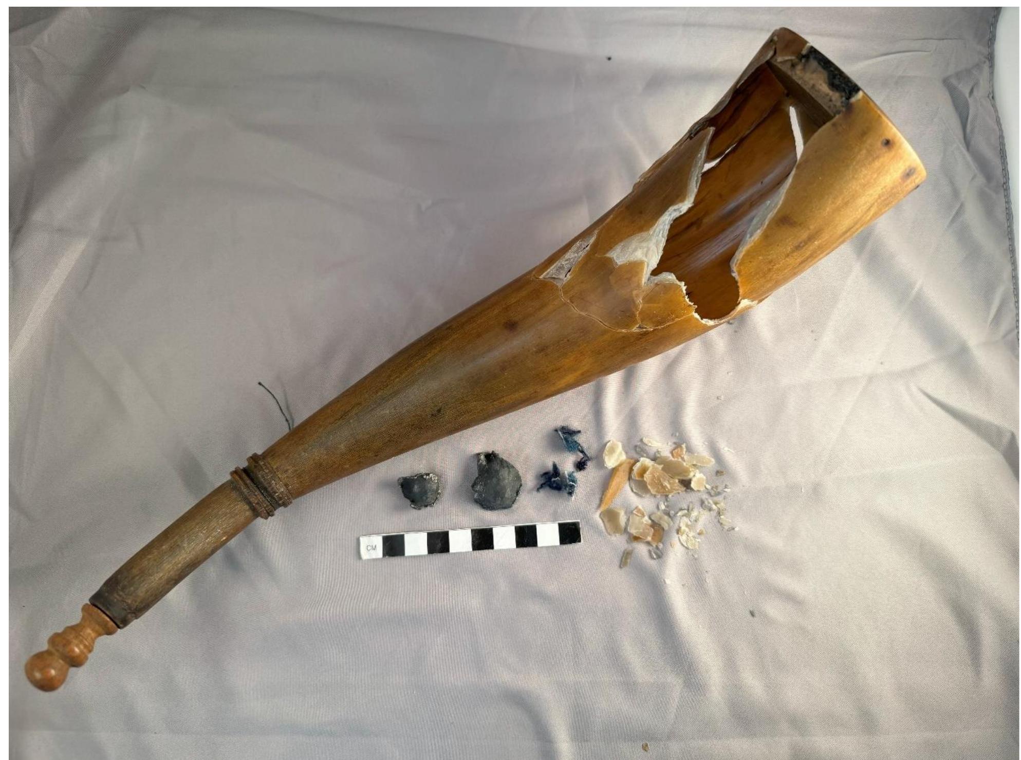 Figure 41. Powder horn 1 reconstructed along with the split ball, cloth, and horn shards taken from the wound track. 