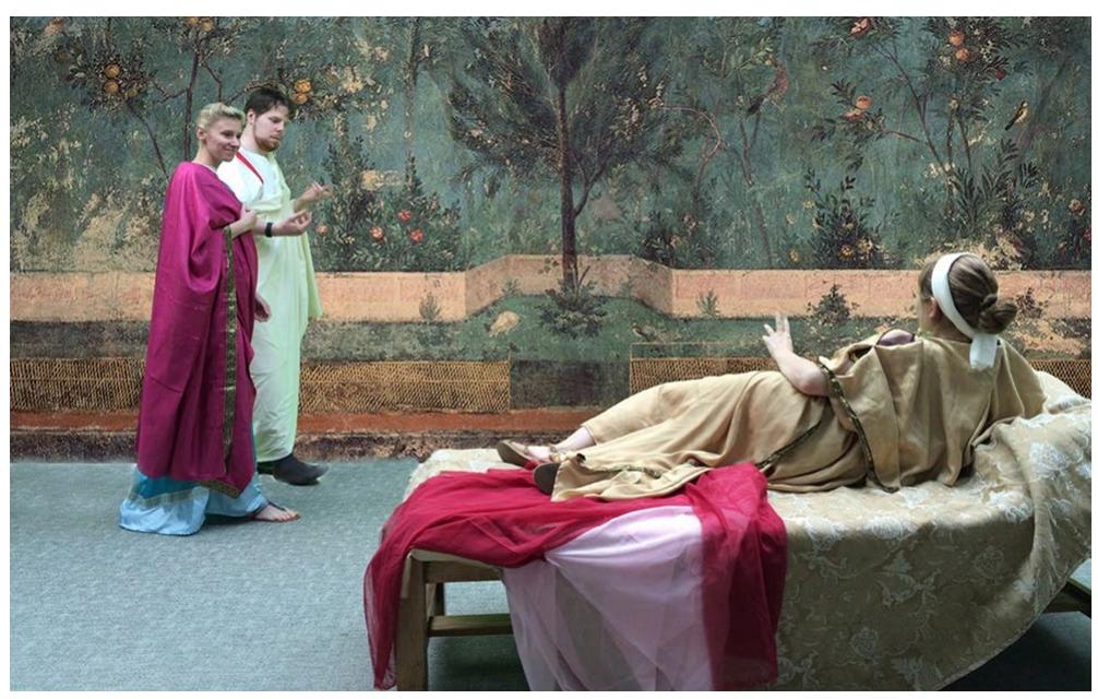 Fig.12 Members of the Gardens of the Roman Empire seminar strolling along the painted garden of Livia at Prima Porta. Author (photo) and Nils Niemeier (green screen)  Connecting the practice of pruning shown in the wall paintings with ars topiaria, the craft of the toparius, ir creating various kinds of plant displays (viridia) in spe- cialized gardens (viridiaria) opens up important new avenues for textual, art historical, landscape architectural, archaeological, and archaeobotanical research. Is what we 