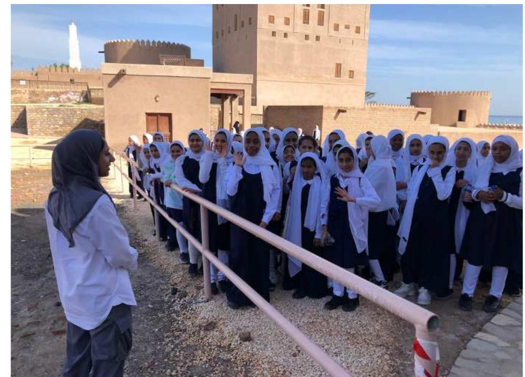 Figure 8. Team member Shuroogq al-Sharqi addresses a visiting school group. Photo Eve MacDonald  Another key aim of the Sohar Archaeological project is to develop a comprehensive community engagement programme (Fig. 8). We hope to work together with key stakeholders to widen the local participation and knowledge of the outstanding heritage of the city of Sohar. A focal point for our activity is the Sohar Fort Museum, which acts as one of the main visitor attractions in the region. This season we welcomed school groups, visiting dignitaries and tourists across Europe, North America, and the Middle East. Encouraging further community participation in and expanding the local appreciation of the unique heritage of Sohar is a key ambition of the project and all its participants.   United Arab Emirates 