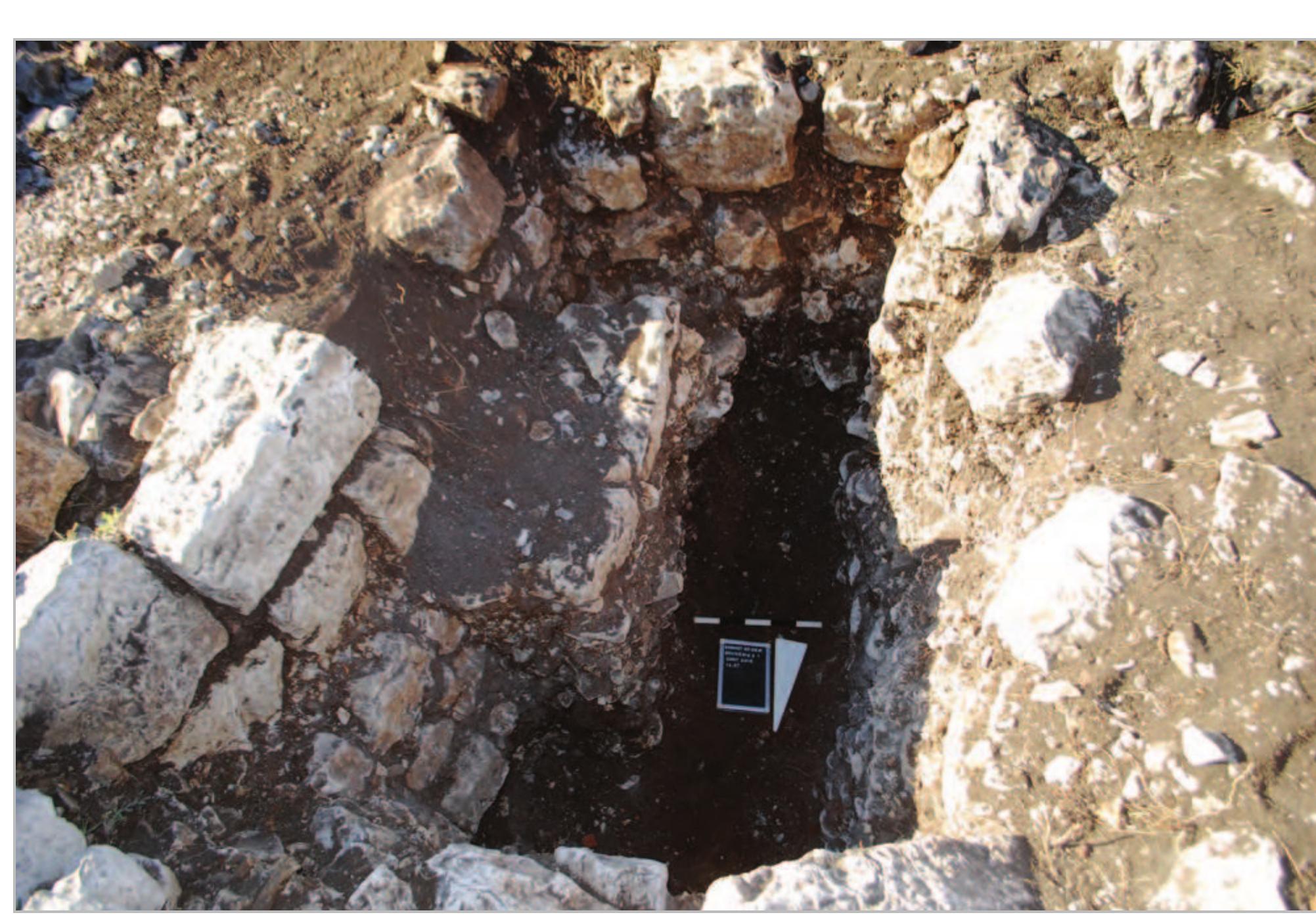 Fig. 8- Area 2/1: the upper step was taken out for reasons of stability.  that the tomb was heavily disturbed, but after several craniums were collected in Context 2026, it became apparent that indeed the skeletal remains below were still articulated, and that the levels underneath had to be excavated by a specialist. The pottery sherds found in the upper layers of the tomb were from the Middle Islamic Period, roughly the 12-15" c. AD.  The data collected so far indicates that this built chamber tomb is a multiple burial. An adult skeleton (individual 2037) with preserved anatomical connection was recorded and excavated, with on top the disturbed cranial remains of three individuals in the northern corner of the tomb (Fig. 16).  built chamber tomb is a multiple burial. An adult  Report on the 2017 archaeological soundings at Qornet ed-Deir, Jabal Moussa Biosphere Reserve 