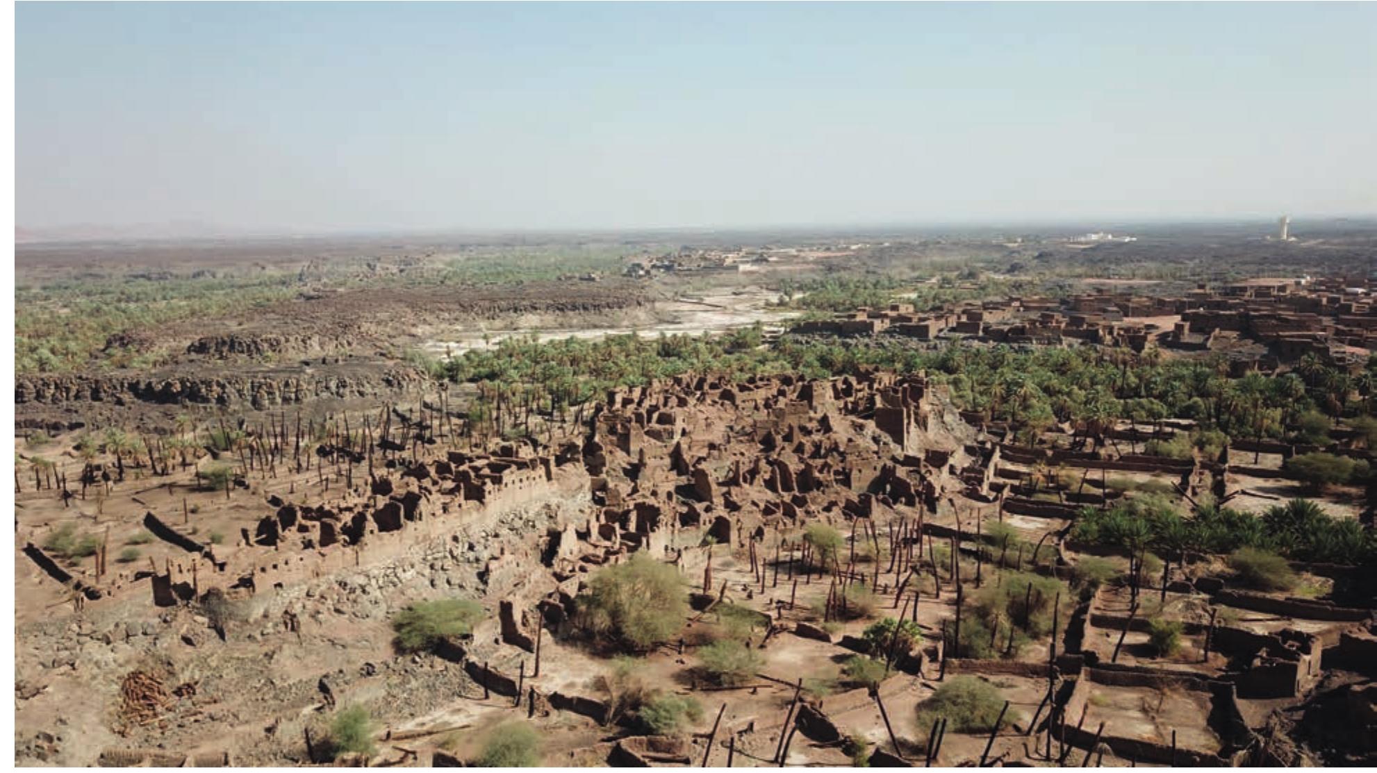 [GURE 1. An aerial view of the Khaybar oasis, looking north-east, Hisn al-Watih in the foreground, Makidah in the background (©Khaybar LDAP, A. Pouget). 