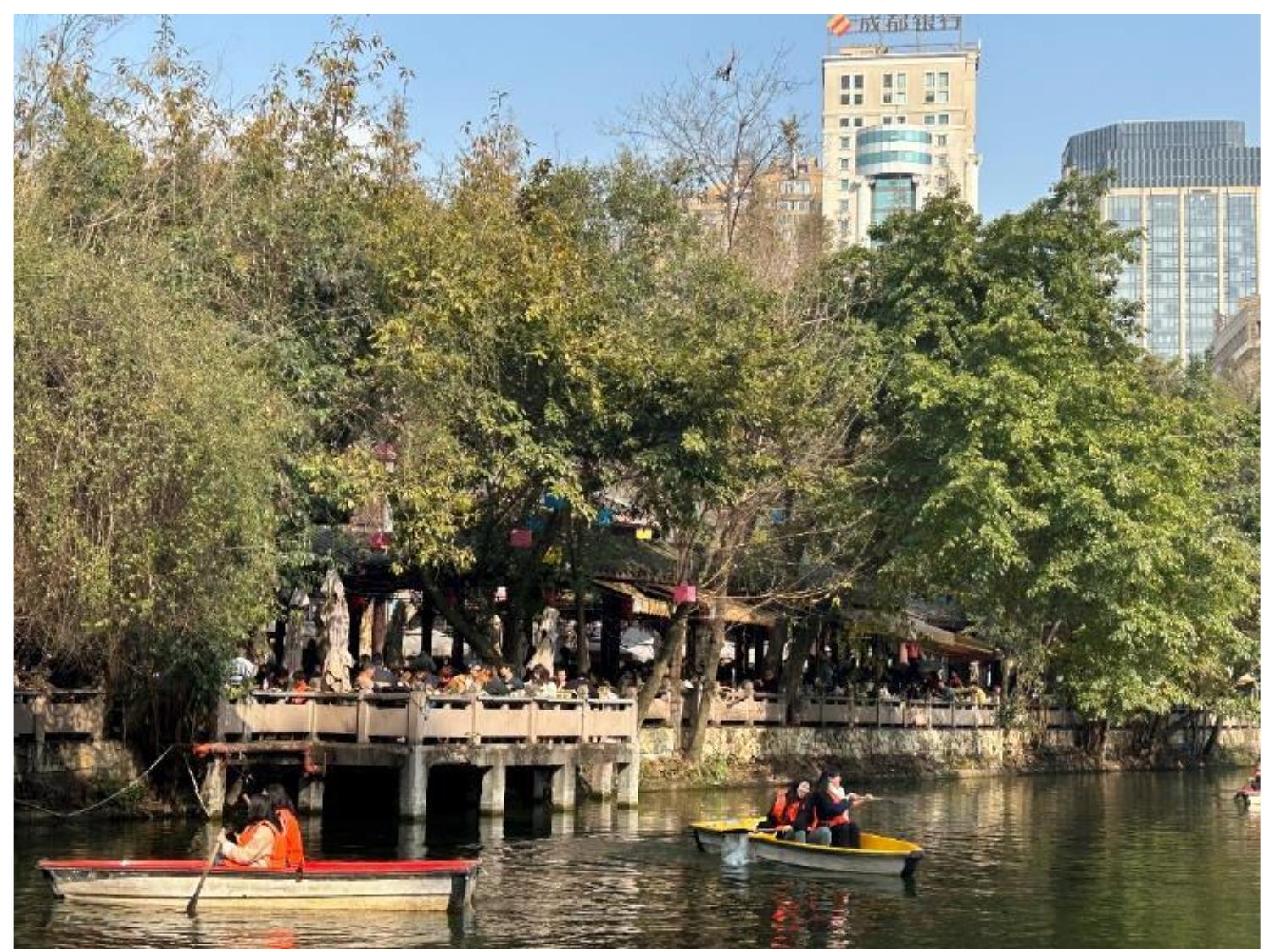 seat, but every step was like intruding into someone else’s social space with no place to land. I eventually left the teahouse, like an immune rejection of the human body. This was my unceremonious first encoun- ter with He-Ming. The teahouse was just a stop on my trip to People’s Park.  Tea drinkers were sitting or leaning on bamboo chairs, playing cards, laughing, drinking tea, and watching the scenery. Tea workers shuttled between spaces, serv- ing tea, pouring water, collecting money, and cleaning up. Theatre actors performed Sichuan Opera, with storytelling, singing, and art of the “long spout teapot.” Venders sold their wares, tea sellers served tea and displayed tea art.  Xu Huang is a humanistic geographer focusing on the fields of psychological geography and literary geography. He holds a PhD in human geography from Utrecht University in the Netherlands and is an associate professor in the Department of Human Geog- raphy at Nanjing Normal University, China. 09432 @njnu.edu.cn. Zichuan Guo is currently pursuing a master's degree in the De- partment of Human Geography at Nanjing Normal University, China, with an interest in social and cultural geography. 231302069 @njnu.edu.cn. Photographic captions are provided on pp. 21—22. Text and photographs © 2024 Zichuan Guo.  