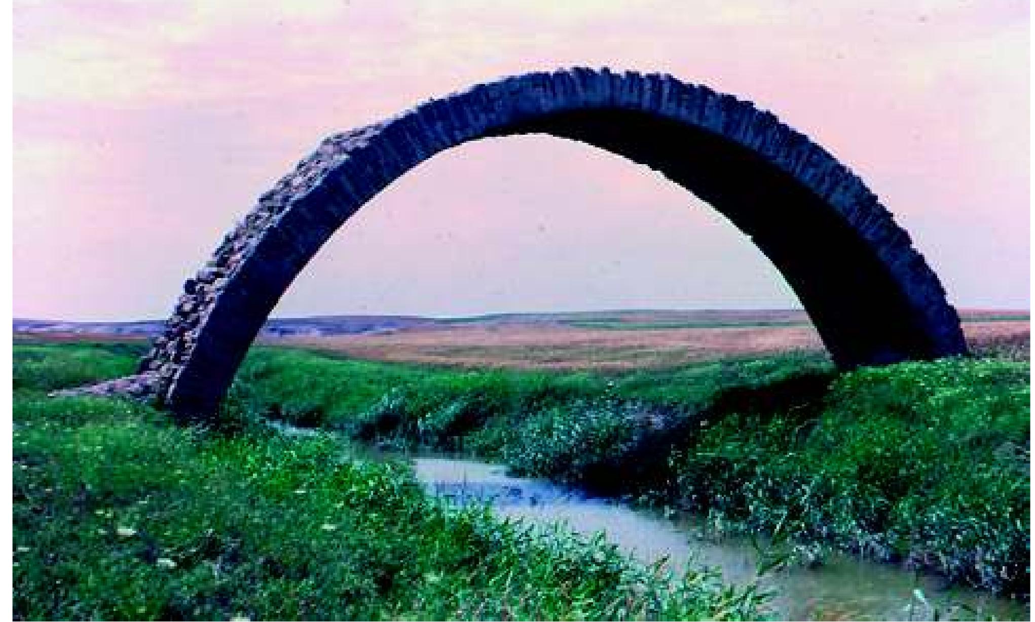 Fig. 8: Eski Mosul bridge: looking west. Photograph: J. E. Reade, c. April 1968  an 1, hence Gomer and Gomar (Walpole loc. cit; Place/ Thomas 1867, II, 161). So Assyrian Gammagara, Greek Gau- gamela and Syriac Gogemal, reduced to Gomel etc, may all have been in roughly the same place, leading Reade (1978, 69) to propose that all these forms might be versions of he same original name. We also have the name of the river beside the Gaugamela battlefield: it appears in manu- scripts of Arrian and Quintus Curtius as Bumad-, Boumel-, Boumell- or Eumell- (+ suffix). So the name is corrupt and no reliance can be placed on it, but the various forms bear a greater resemblance to the Assyrian river-name, Pulpul- ia, now the Gomel, than they do to the name of the Khazir River, Assyrian Hazur, which passes near Karamleis.   The battlefield, however, should not have resembled in its condition the south-eastern side of Navkur, where the sur- face of the ground, as described by Layard (1853, 367), is not only very muddy in spring, but badly cracked and fis- sured in summer, so that it is difficult for pack-animals. 