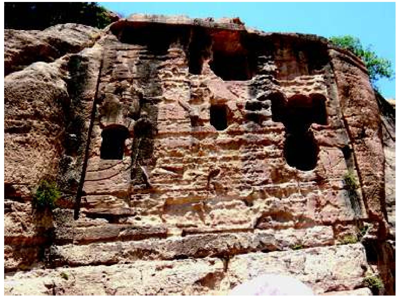 Fig. 38: Khanes: Large Panel showing Sennacherib worshipping Ashur and Ninlil, pierced by entrances to later tombs. Photograph: authors, June 2009 