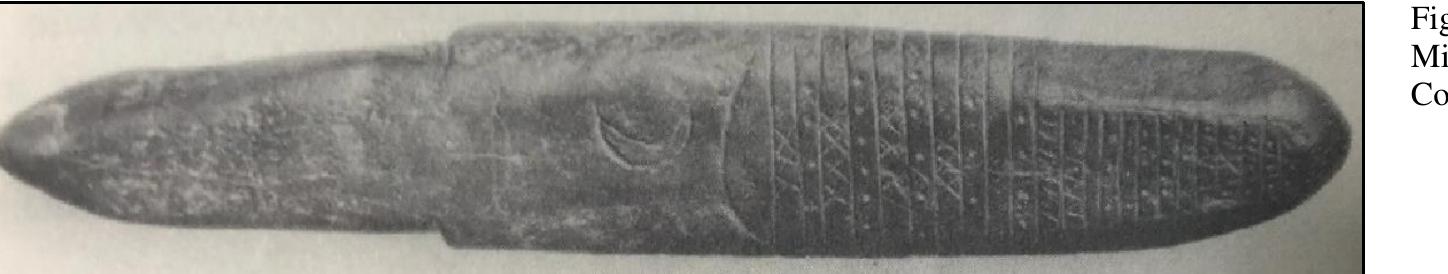 The artifact is a smooth, polished black stone that measures 40 cm (16 inches) in length and 7 cm (2 % inches) in maximum width. The stone was cut and pecked to some extent to form its overall shape. Tiny peck marks are particularly visible at both ends of the stone and scattered along the rest of its surface. About one-third of the proximal end of the stone (left in Figure 92) appears to be where the artifact was hand-held, or, alternately perhaps this end was inserted into a socket of a wood handle. Cut marks are evident at the juncture of this section and the main body of the artifact. The stone is generally ovoid in cross section.  The stone has one relatively flat surface that contains incised images and geometric symbols. The images consist of a bow and arrow, followed by a crescent moon, and then a curved line. To the right of these images, the surface of the rock has been divided into 23 sections or rectangular panels. Within these sections are alternating designs of three Xs, six dots, four Xs, six or seven dots, three Xs five dots, three Xs, six dots, a blank section, four dots, slanting lines, a zigzag pattern, a blank section, then nine sections containing dots. A V symbol is present at the distal end. Finally, two incised lines that form a V are present along the handle (?) section. 