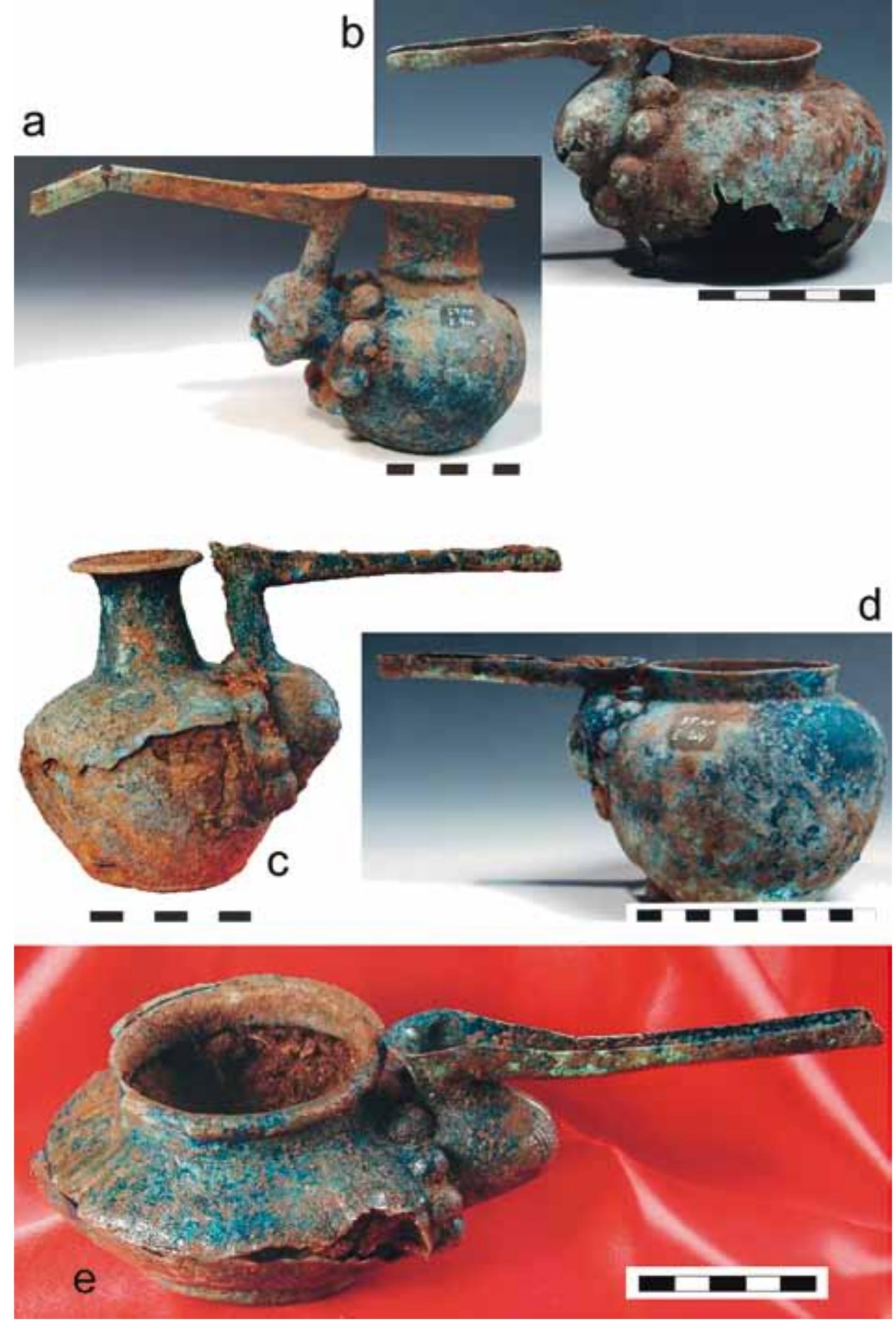 Pl. 3. Selection of bronze spouted vessels from the 1“ excavation season at Sangtarashan.  a. ST84 E.100, a rare specimen decorated with a human head; b. ST84 E.099; c. ST84 E.102; d. ST84 E.107; e. ST84 E.145. 
