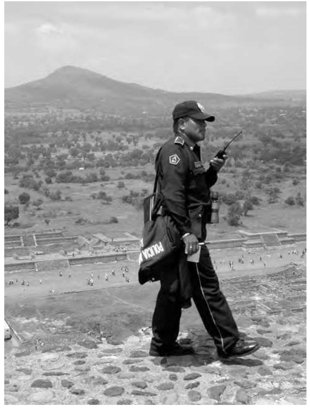 Figure 3.4: Ontological politics: INAH security patrols on top of the Pyramid of the Sun (Image: Webmoor).  Outside of the fence the types o  f exchanges with material  from the site are more difficult to monitor. Teotihuacan is more flexibly composed as other pasts on the margins. Yet  even here the action of the TM  P map continues to guide  engagement. It acts at-a-distance through a different set of networks (Latour 1986, 219-232). If more diffuse, the  map has wider agency. As a sti  pulation of Teotihuacan’s  listing as a World Heritage Site in 1987, the United Nations Educational, Scientific and Cultural Organization 