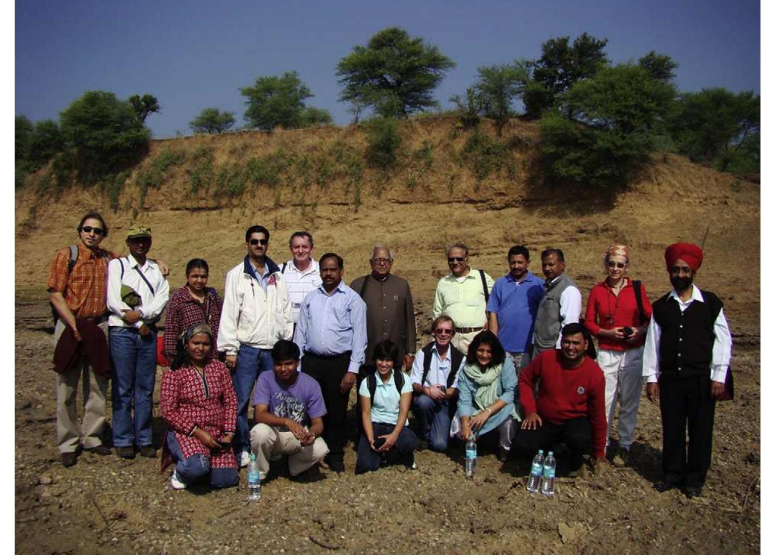 Fig. 2. Conference delegates on a field visit to the hominin fossil site of Hathnora.  In recent years, several specific hypotheses have been offered in relation to various time periods of human occupations in South Asia (see Table 1). Although most of these hypotheses require empirical testing and/or further confirmation, they reflect the importance of  Archaeological Survey of India. Academic departments or centers dedicated to paleoanthropology are very much needed in South Asia to continue the study of prehistoric human evolution in the region, especially considering the high rate of site destruction from increased development, widespread agriculture and other factors. 