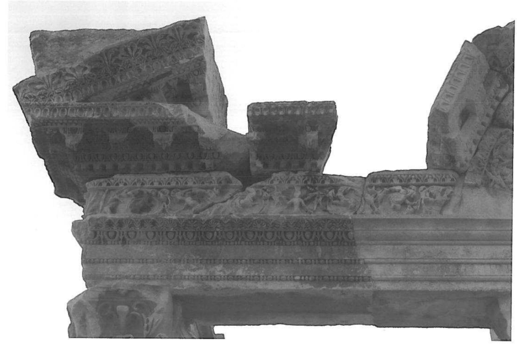 Fig. 10. Western horizontal architectrave of the street facade, ancient replacement (© OAI)  on the W side, which broke into two pieces and was repaired using iron clamps™ (fig. 5). The westernmost horizontal architrave on the street front (fig. 10) is an example of a replacement of an original block. The decoration of the soffit reveals major differences n the decoration, also visible at the front. The soffit panel lacks the framing kymation ind its decoration is only a schematic copy of the original. The egg-and-dart at the front, oarticularly the casing of the eggs, is much coarser, and the bead-and-reel is decidedly ess filigreed than its Hadrianic counterparts (fig. 7 and 11). This substitution of an older iece also explains why the beginning of the original dedicatory inscription is missing. ‘urther, two cornice blocks of the front arch deviate from the rest of the ornamentation ind might be replacements. To judge by its design, the base underneath the western- nost front column (fig. 12) must also be part of this repair.*> The above evidence shows hat the W part of the front hall, including the western column and therefore the arch of he Syrian pediment, collapsed. Replacements of blocks and ancient repairs can only be ound in this part of the pronaos. During the rebuilding, the amta wall on the W side was hortened (figs. 3 and 5) and, in accordance with the change, the relief underneath the chitrave was probably cut back. This W side was designed as a doorway to the next- loor structure, but because this neighbouring area subsequently underwent changes the jopearance and function of that space is hard to discern.  