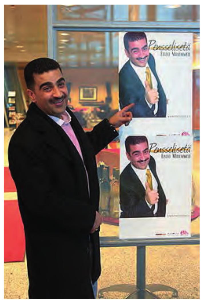 Ebdo Mihemed and an advertisement for his album The Best of PensselisetG (‘Uncle Push Broom’)  20-year career as a professional wedding singer. 