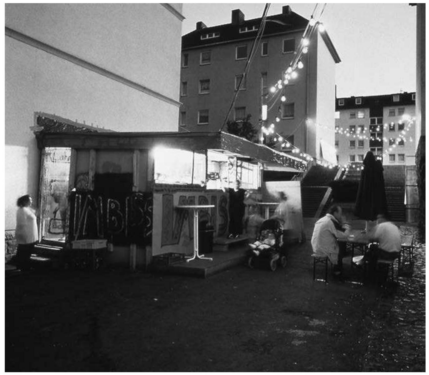 Thomas Hirschhorn, Bataille Monument, 2002 (snack bar), documenta 11, Kassel, 2002  If the Bataille Monument itself consists in part in the selling of kebab, lending videos, and broadcasting amateurs, in short, in the social connec- tions and press that the work generates, it follows that the monument is a temporally and physically distributed event. Following this idea, one could consider Hirschhorn’s statement, the newspaper interview and the resulting article, and other such acts and objects, as themselves parts of the monument, since they partake in the creation and maintenance of its social goals. Indeed, such a way of reading the publicity around the monument can hardly be seen as against the grain, since the statements in question fit the requirements for a ‘monument from below’ that Hirschhorn himself articulated. These strat- egies are more familiar from ephemeral urban performance art than from monumental sculpture.’® But they are not the end of the story. After the ‘precarious, ‘ephemeral’ exhibition has ended, there remain individuals who remember having participated in or encountered the work, and documents and artefacts that recorded its presence. The public statements and press clips that seemed so ‘action-like’ a moment ago immortalize the project as 
