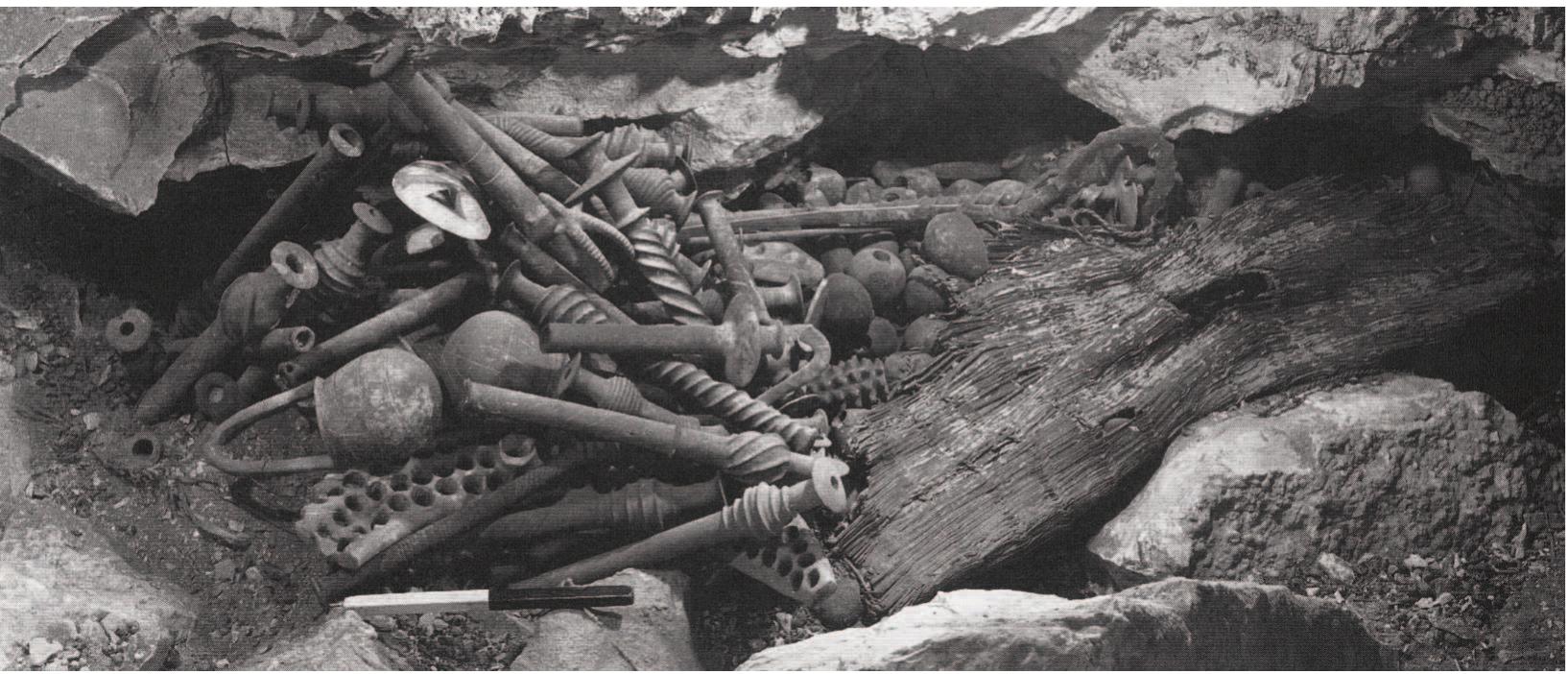 Figure 17. The Nahal Mishmar hoard as found in the cave. Photograph courtesy of the Israel Exploration Society, Jerusalem. Figure 18. Copper scepters found in the Nahal Mishmar hoard. Israel Museum, Jerusalem. Photograph courtesy of Wikimedia Commons, Hebrew Wikipedia user Hanay. http://commons.wikimedia.org/wiki/File: Treasure_of_Nahal_Mishmar_(5).jpg.   Goren now assumed that the examined materials were the remains of the casting molds of the metal objects which were  Thirteen years later Goren published a new study on the articles of the hoard (Goren 2008). The core of all the above- discussed thirteen objects was now defined - based on the same data of the analyses made in 1995 — as having “the petrographic characteristics of the Moza Formation of central Israel...or ren- dzina soils mixed with sand of chalk or limestone and abundant vegetal matter” (379). 