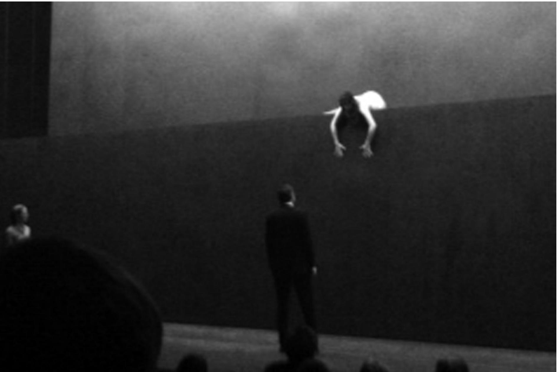 Euripides' Medea, directed by Michael Thalheimer. Photo: Courtesy of Theatertreffen.  fro to UIG UGoU Willi lildily 10auilly UUlilidil directors, Thalheimer works almost exclusively with a single designer, Olaf Altman, who is clearly co- equal with Thalheimer in creating the distinctive world of their productions. Altman's setting for Medea ultimately recalls the minimalist but enormously powerful settings he created for previous Thalheimer productions, especially the Oresteia, but this similarity was by no means apparent as the production opened. We were greeted with what appeared to be a completely empty, grey stage, the cavernous performance area of the Festspielhaus stripped to the walls, with only an occasional lighting instrument visible. Nothing apparently could be further from a typical Altman design which totally fills the visual field with monumental walls and inclined planes. As the production begins, the central section of the apparently solid back wall rises, revealing a shallow inner stage, distinctly recalling that of the Orestia, but farremoved from the   The 2013 festival began spectacularly with a production of Euripides' Medea, created by a number of the most highly regarded artists of the contemporary German stage. Its director was Michael Thalheimer. Thalheimer has had six productions selected for the Theatertreffen, most recently the Oresteia in 2007 and Hauptmann's The Rats in 2008 (both reviewed in WES). The powerful minimalist style of Thalheimer is one of the most  