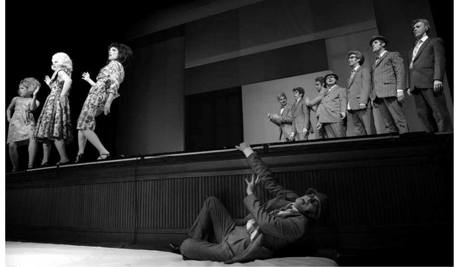 Herbert Fritsch's Murmel Murmel. Photo: Thomas A urin.  I had seen the second Theatertreffen offering, Herbert Fritsch's Murmel Murmel, last year in Berlin, but the second viewing was just as delightful as the first. Fritsch is today one of the most popular directors in Germany and arguably the  No children appear in this minimalist interpretation and no exiting chariot. The death of the children is presented as an animated video, created by Alexander du Prel and projected directly onto Medea. In a large black and white box, simple figures of a family like the stick figures on traffic signs indulge in a sequence of everyday family activities, playing, walking, reading, traveling, even watching TV together. The images speed up and flow into one another until finally they are replaced 