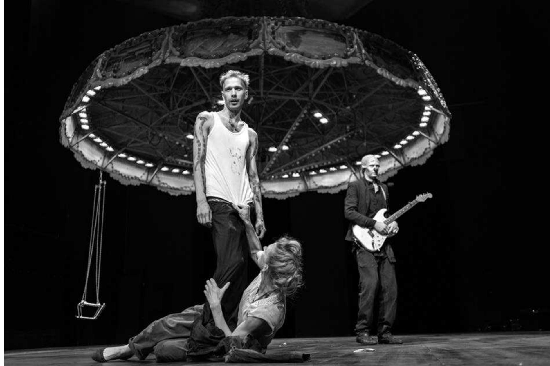 Tennessee Williams's Orpheus Descending, directed by Sebastian Nubling. Photo: Julian Roeder.  The stylized, cartoon-like approach was less troublesome with the settings by Thilo Reuther, using simple forms and imaginative projections to create a fantasy world full of international but especially American pop culture icons. A concluding video montage summed up these images, suggesting the rise of modern America from the 1970s onward, culminating in Barack Obama, while the groups of costumed characters (the workers in red, the capitalists in blue, and the Salvation Army members in white) were suddenly reinforced by an image of Spiderman, wearing a skin-tights suit of these same colors and backed by a huge American flag. The evening seemed on the whole as much an ironic celebration of the icons of late capitalism as a critique of it and while it was unquestionably a   Parody and slapstick suffused the evening, pop culture references abounded, from “Lucky Luke" to "Modern Times," to vampire and zombie 