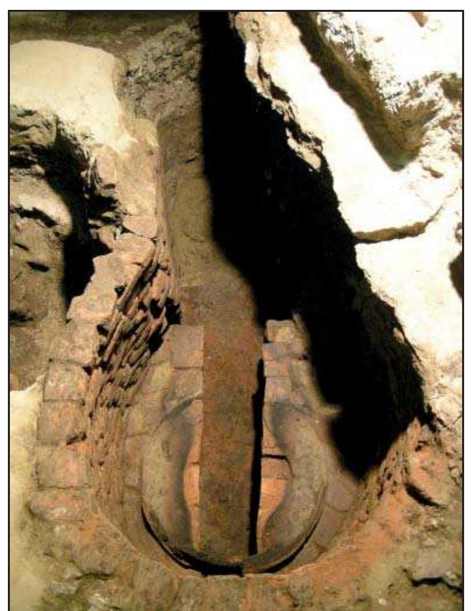 Fig. 3.63 The most well-preserved casting pit found at the excavation of Palazzo Scotto. Of note are the praefurnium and the elliptic firing chamber with two sections upon which the mould base of the last bell cast is visible. A blackened circular ring can be seen inside the mould, caused by the combustion needed to melt the wax of the false bell and  harden the mould. 