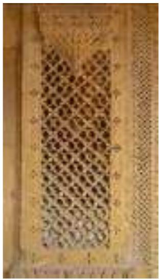 The exquisite carvings done on sandstone show a stylistic similarity to details in wood carvings. It can probably be due to near visual resemblance of the golden sandstone with wood and an urge of the rich merchants to imitate rich wood carving patterns from facades of Havelis in Gujarat in their own local material i.e. Golden sandstone to give their works a long lasting identity.  Figure 18 A sandstone Jaali resembling wood work carving 