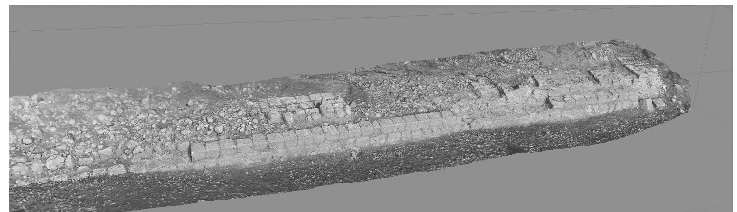Fig. 3. Digital photogrammetric 3D restitution of the quay seen from the east (© Institute for Technologies Applied to Cultural Heritage, National Research Council, Rome).  The quay is a structure of limestone blocks measuring ca. 28.9% x 3.1 m located on the right bank of the River Gomel, opposite the village of Zinawa Ghazi on the left bank (Figs. 3-4). It stands approximately 300 m east of the small site of Ashka Krab (no. 265) on the right bank of the Gomel’ and about 600 m north of the larger site of Tell Taleb (site no. 266), a tell heavily eroded by a meander of the Gomel located on the same bank and occupied mainly in the Middle Bronze Age, Middle Assyrian, Neo-Assyrian and Hellenistic periods. 