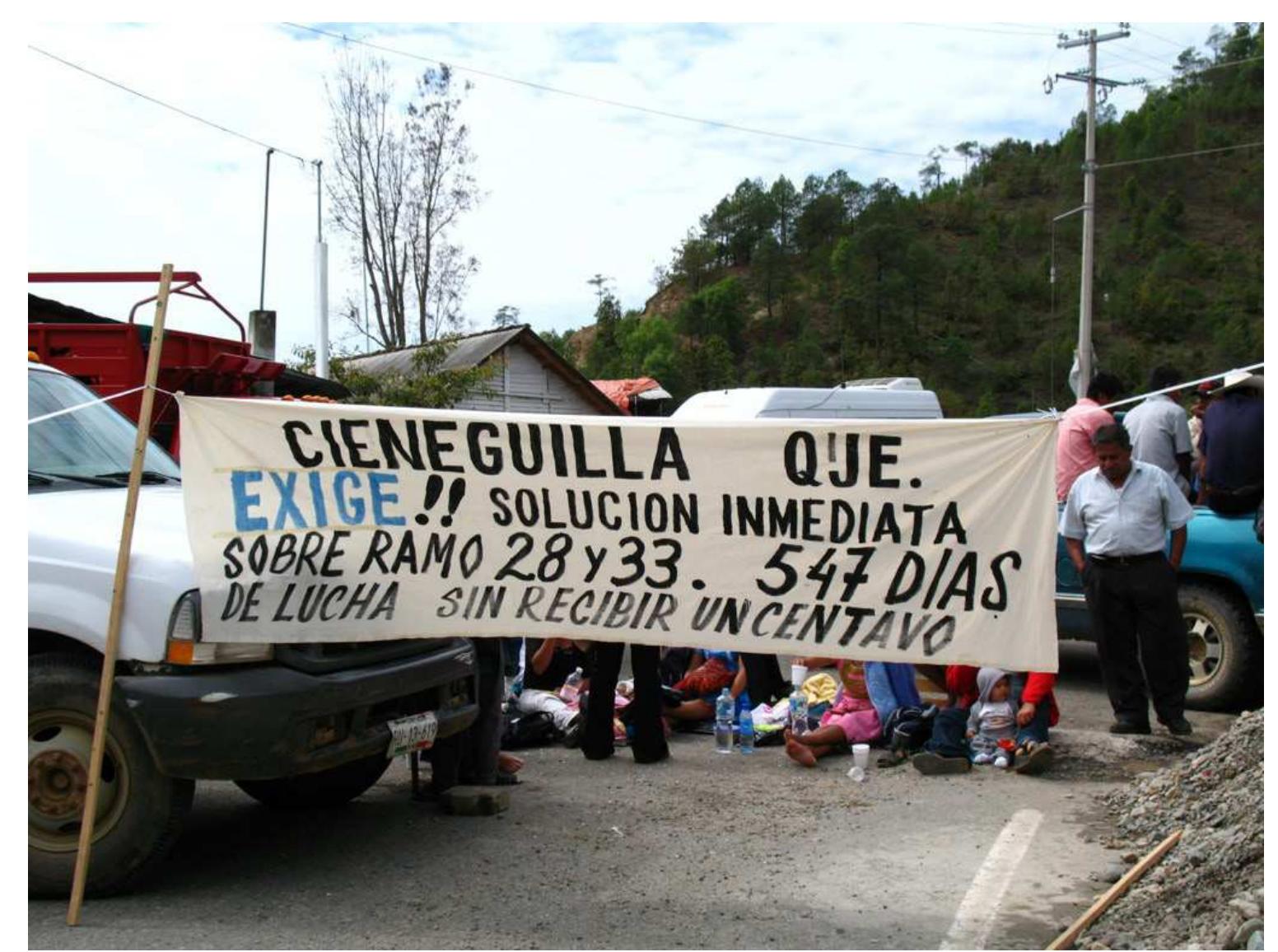 Ficure 11: Highway blockade by citizens of Cieneguilla, Cerro El Vidrio, Juquila, June, 2007. The sign calls on San Juan Quiahije to share municipal operating funds with Ciene- guilla, saying: “CIENEGUILLA, QUIAHIJE DEMANDS!! AN IMMEDIATE SOLU- TION REGARDING (LEGAL) SECTIONS 28 AND 33.547 DAYS OF STRUGGLE WITHOUT RECEIVING A PENNY” (Photo by Emiliana) 