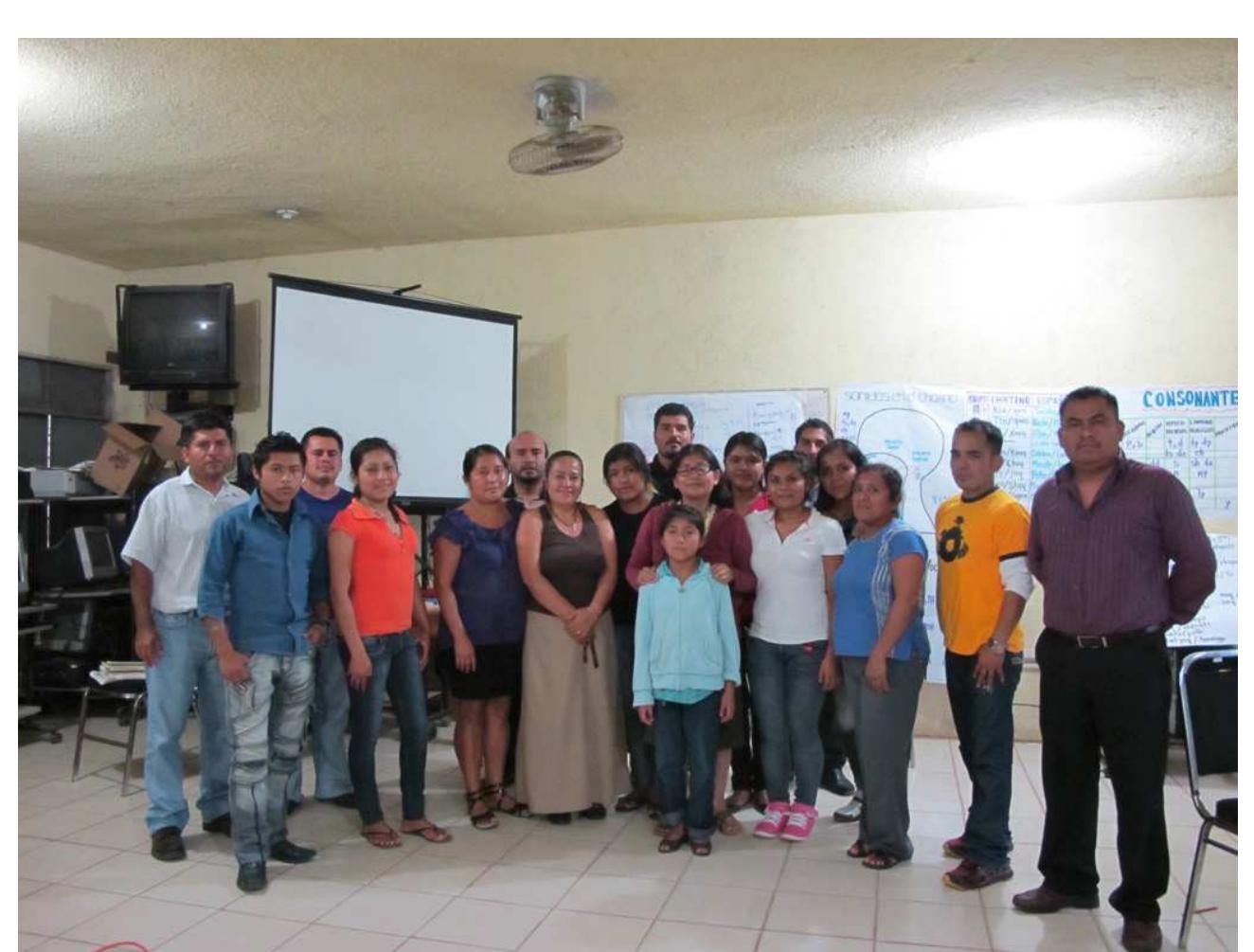our own workshops. The most recent instances were in Summer, 2013 in Santos Reyes No- pala, long the center of linguistic activity by maestros bilingiies (Figure 15). The workshop was well attended and teachers were eager to learn about Chatino and our work. Though people are becoming more aware of us, we constantly have to negotiate with different par- ties. We let them know that we propose to train indigenous Chatino speakers to document their own languages, and to give them the linguistic tools to determine a writing system in conjunction with teachers and other speakers. Teachers have been more open to working with us once they know about our approach.  Ficure 15. Emiliana (at center, with hands on child’s shoulders), her student-trainees, and maestros bilingiies at the third workshop on normalization of Chatino in Santos Reyes Nopala 