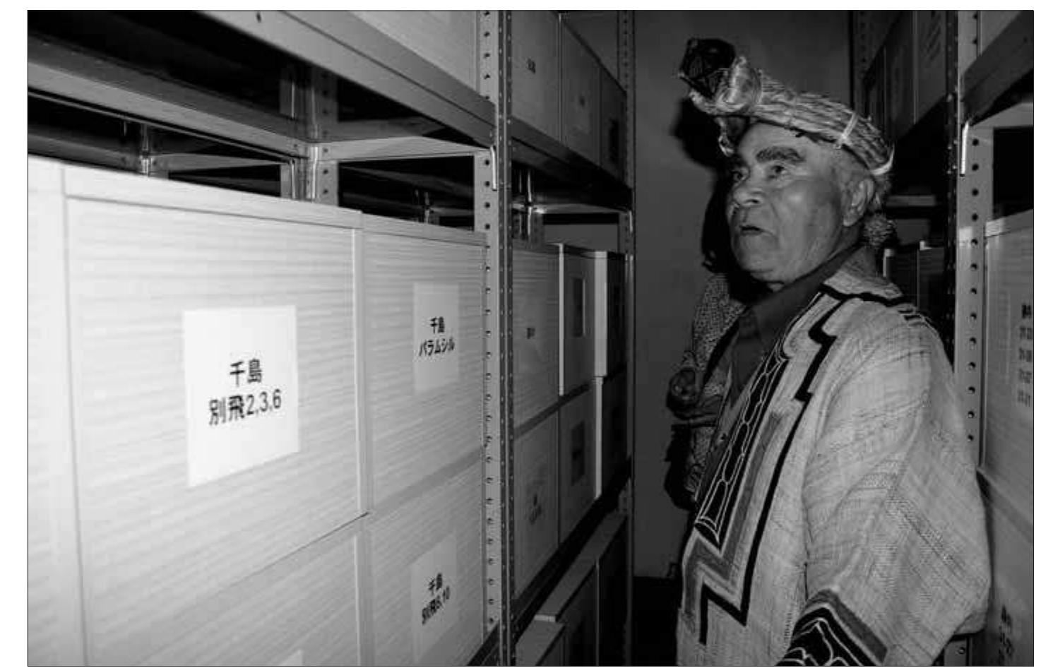Fig. 1. Ainu activist and ecotour guide Ogawa Ryukichi stands before the boxed Chishima [Kurile Islands] collection of Ainu skeletal remains (51 total) indicating the breadth of the mass grave excavation research and emphasizing that the skeletal remains issue is an on- going problem with ramifications for Russian-Japan relations. (All photographs by author) 