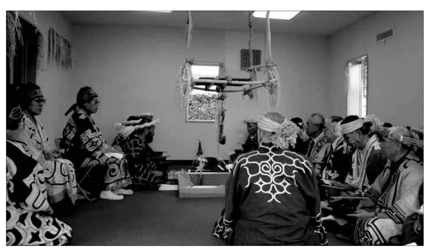 Fig. 2. Memorial ceremony: Inside the charnel house, Ainu elders from across Hokkaido pray to appease ancestors whose bones were stolen from communal burial grounds for an- thropological research during the twentieth century. Skeletal remains of 969 persons are housed in the facility, while 35 have been returned to Hokkaido communities. 