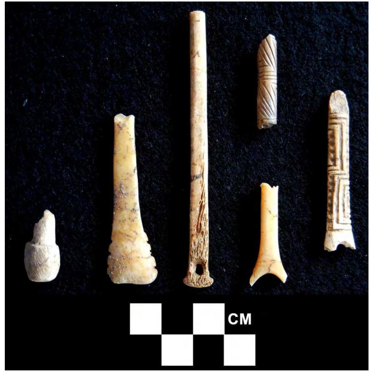 Figure 20. Various pin fragments showing surface decoration and a Crutch-top type with a hole. 