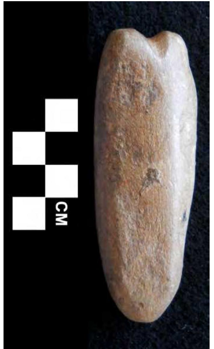 Figure 25. Elongated polished and grooved hematite object. 