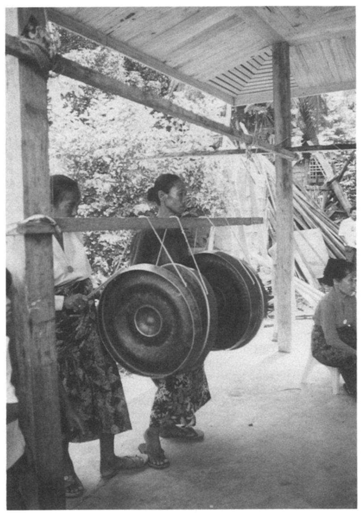 The woman on the right plays the gandingan, while the woman