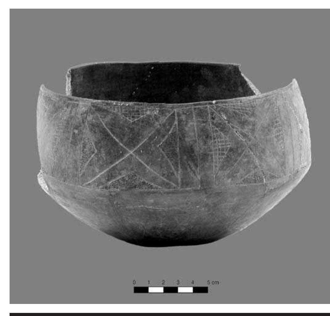 FIGURE 4.7. Carinated bowl, possibly White Engraved (423148).  This designation was given to a large simple-carinated bowl (423148) with a band of motifs formed around a cross or “X” pattern along the upper outer edge (Figures 4.5b, 4.7). The paste is gray clay with a medium-fine texture, and 