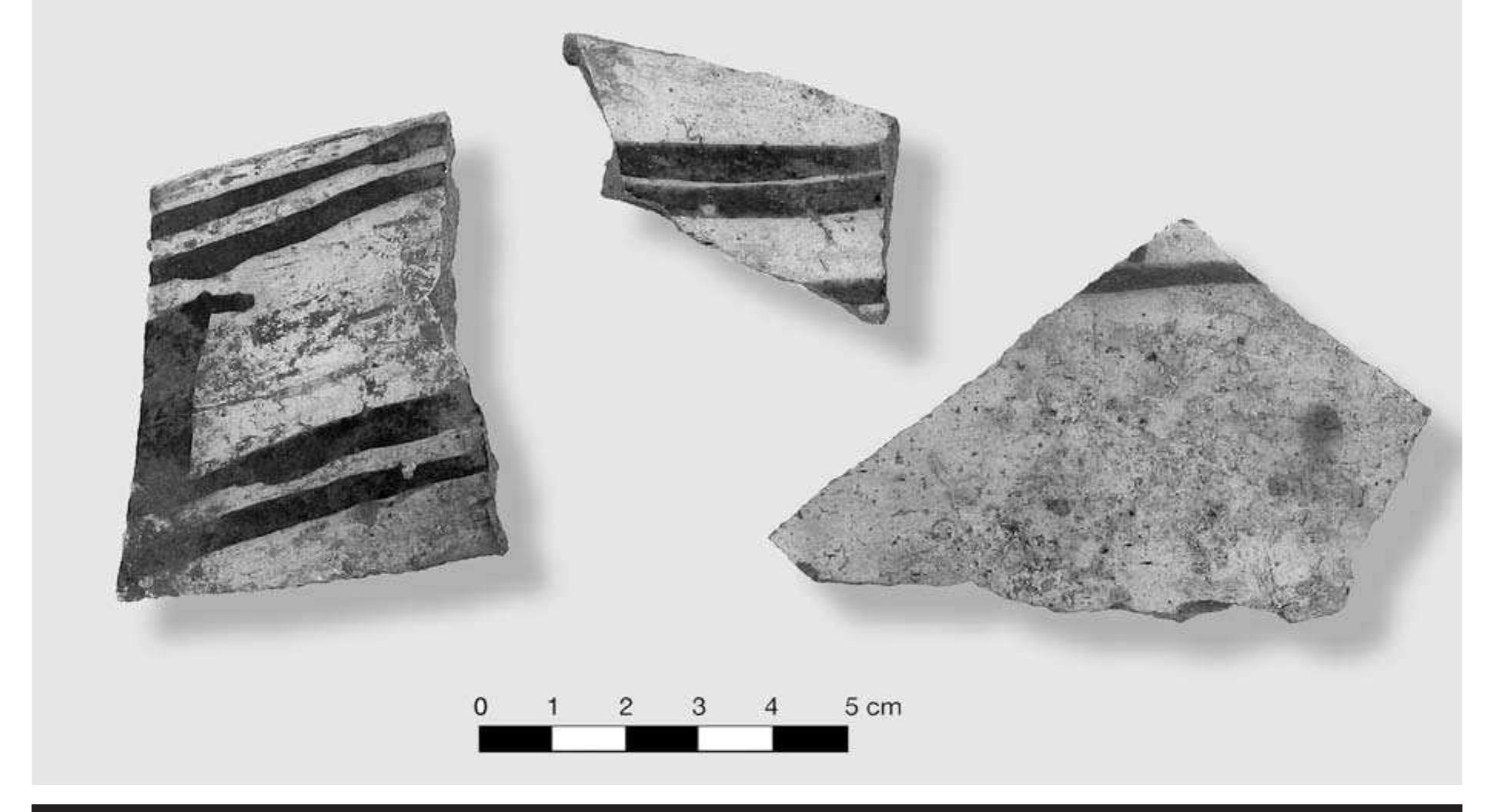 FIGURE 4.11. Non-Caddoan Southwestern sand- and grit-tempered sherds with black-on-white design (423151).  In addition to these wares, there are sherds that ap- pear to be from a far-removed archaeological context. In particular, there are six sherds from black-on-white painted vessels, white slipped and blackened sand- tempered wares (Figure 4.11). They are characteristic of Southwestern ceramics styles. Although it is possible that these sherds demonstrate interaction and trade with cul- tures of the American Southwest, it is also possible that these sherds are not from Spiro at all. In his study of over 15,000 sherds from the WPA excavations, Brown (1971b, 1996) does not record a single sherd of Southwestern con- struction or decoration. Because of the loss of provenience for this material as it was passed from antiquities dealer to collector, it is possible that some artifacts were reputed to have come from Spiro, when, in fact, they did not. All  Other ceramic elements include nodes, lugs, or han- dles. There is one strap handle from a highly polished red 