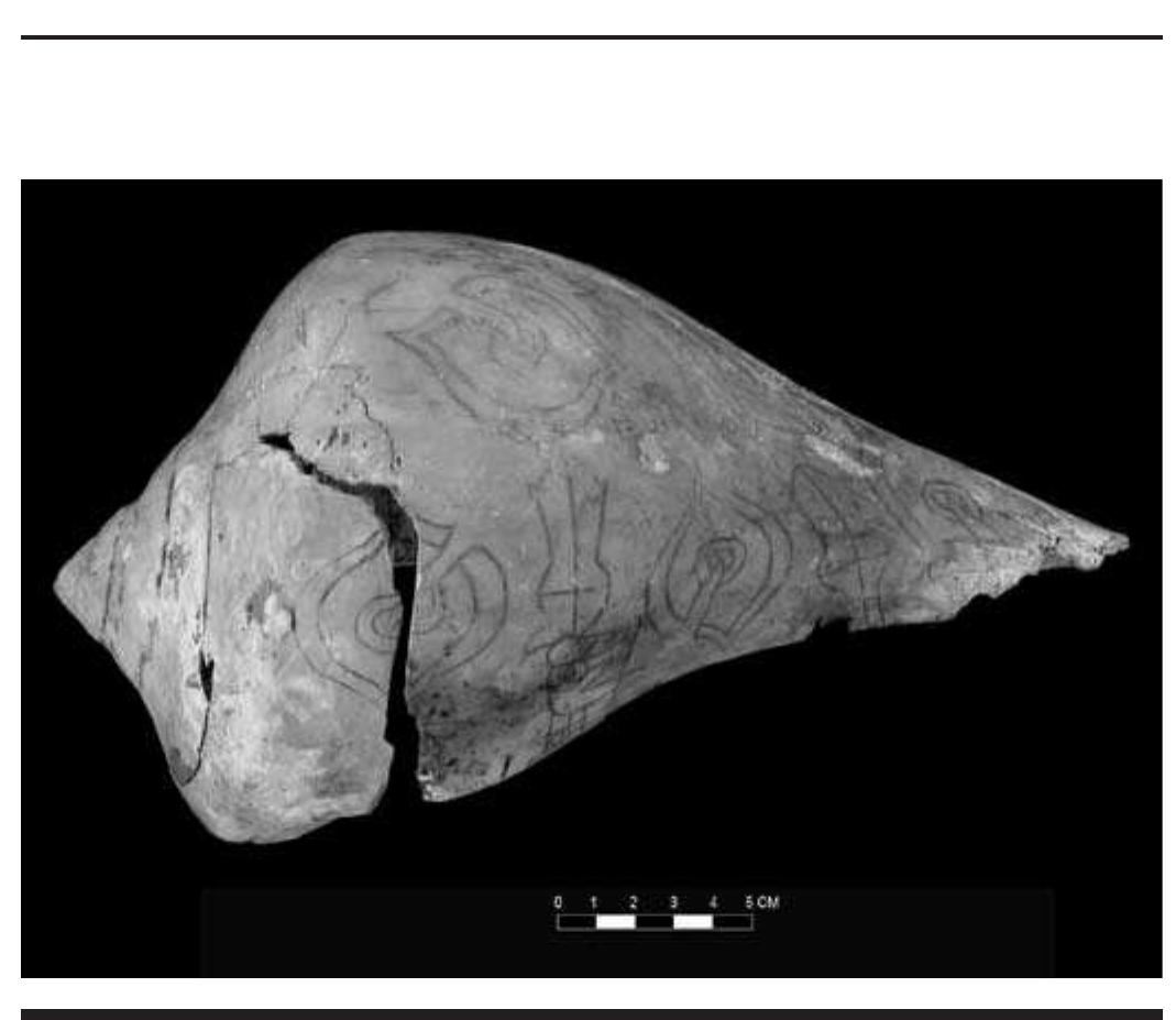 FIGURE 4.23. Mace, ogee with streamers, human head, and bilobed arrows on two sides of Braden B style shell (448785). 